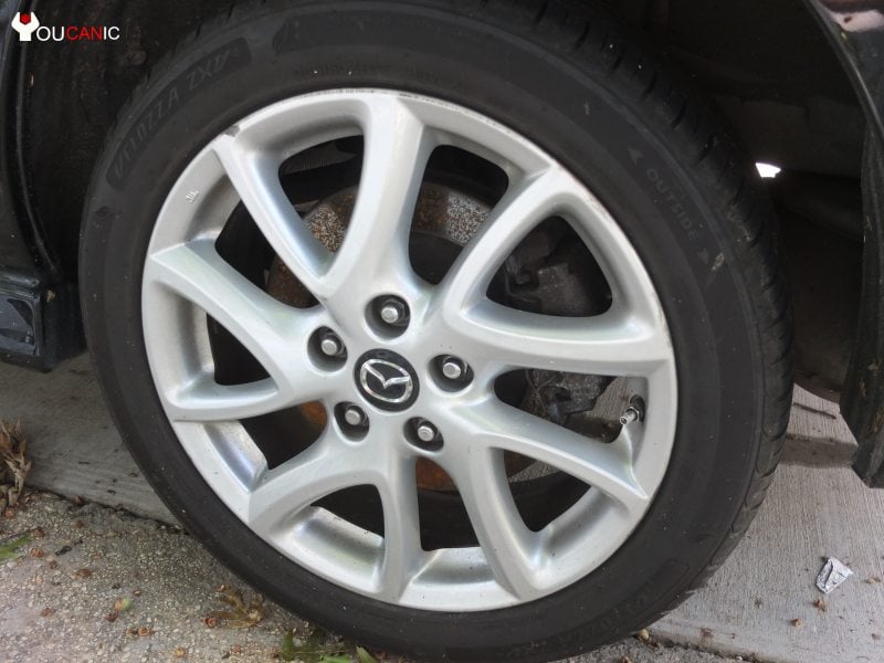 remove wheel to change brake pads on Mazda 5
