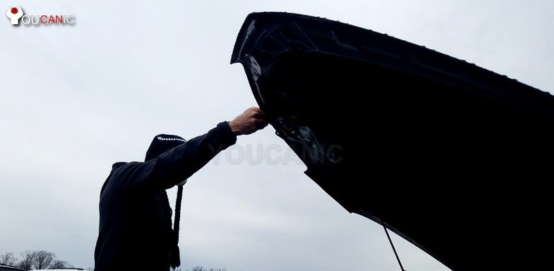 hold up BMW 3-Series hood by hand