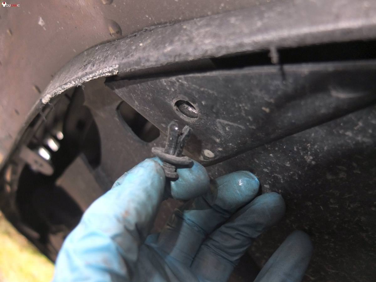 remove bolts from lower engine cover to access drain bolt to change oil