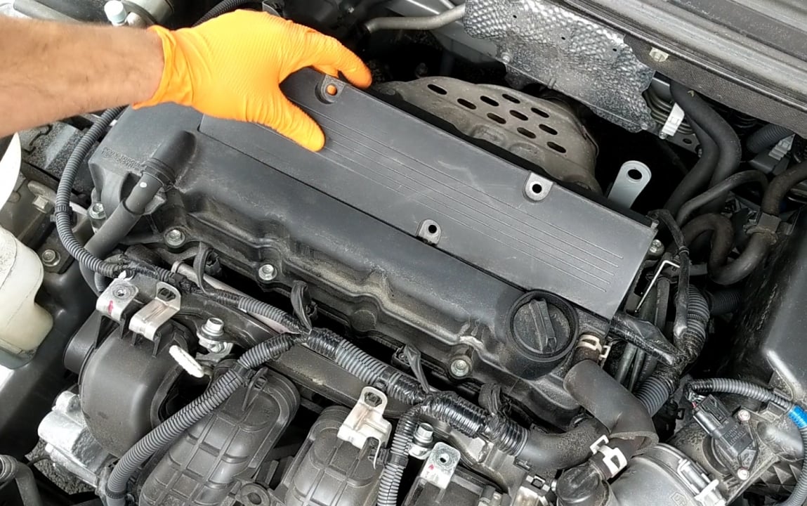 remove engine cover to replace mitsuibshi spark plugs