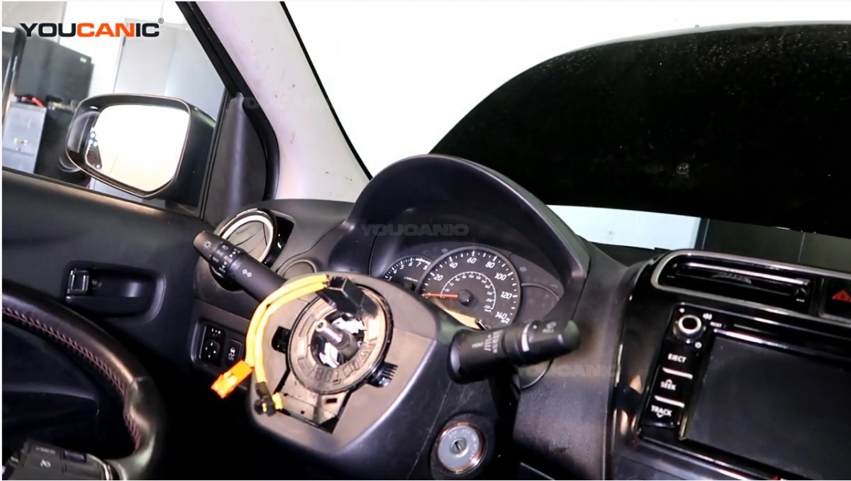 Removing the steering wheel of the Mitsubishi Mirage.