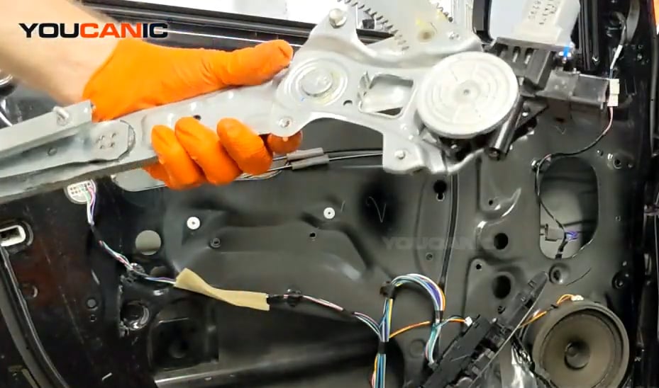 Installing the new door regulator motor of the Mitsubishi Mirage.