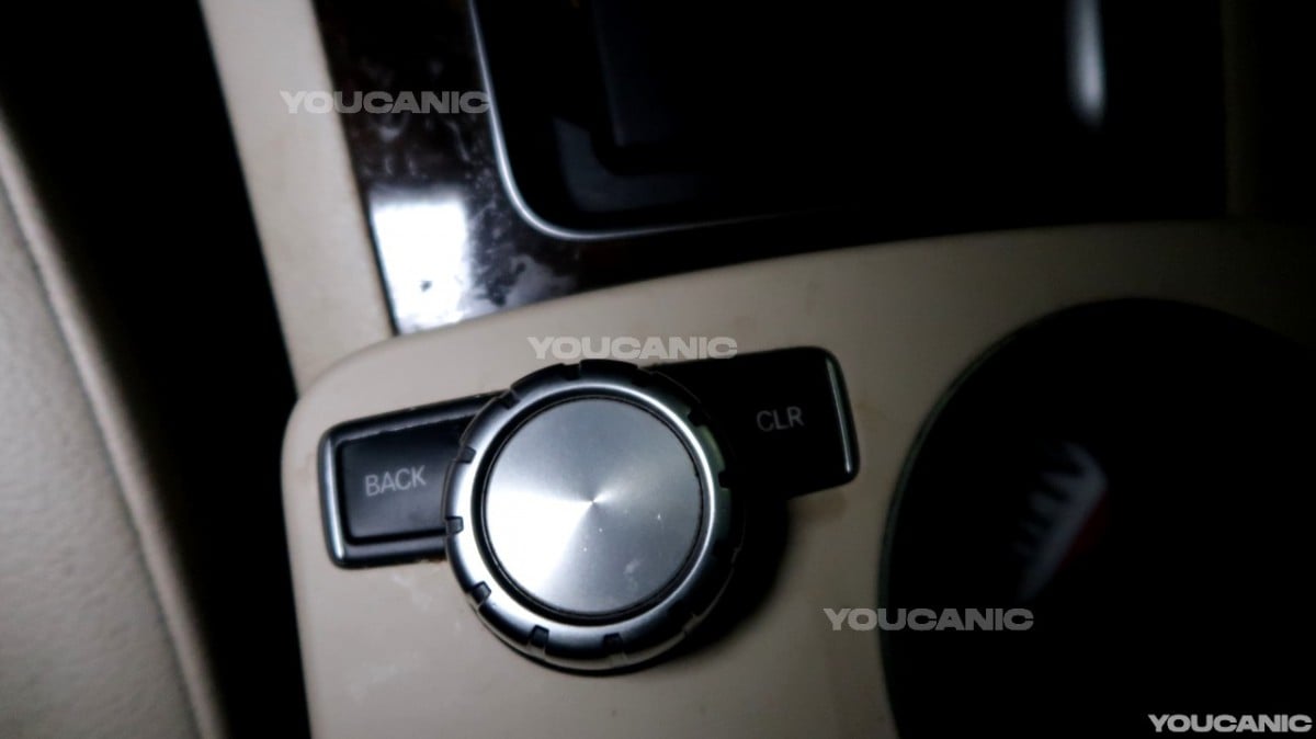 The toggle on the center console of the vehicle.