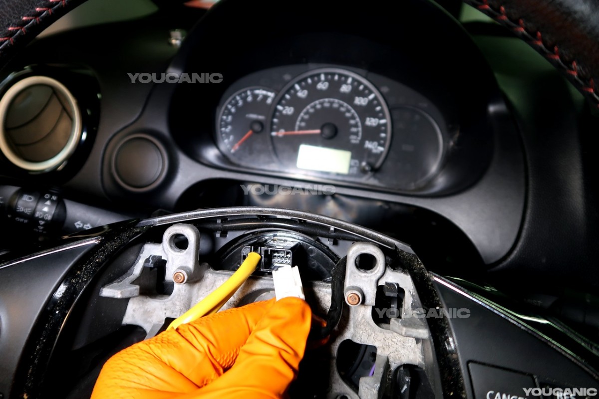 Removing the electrical connectors from the steering wheel.