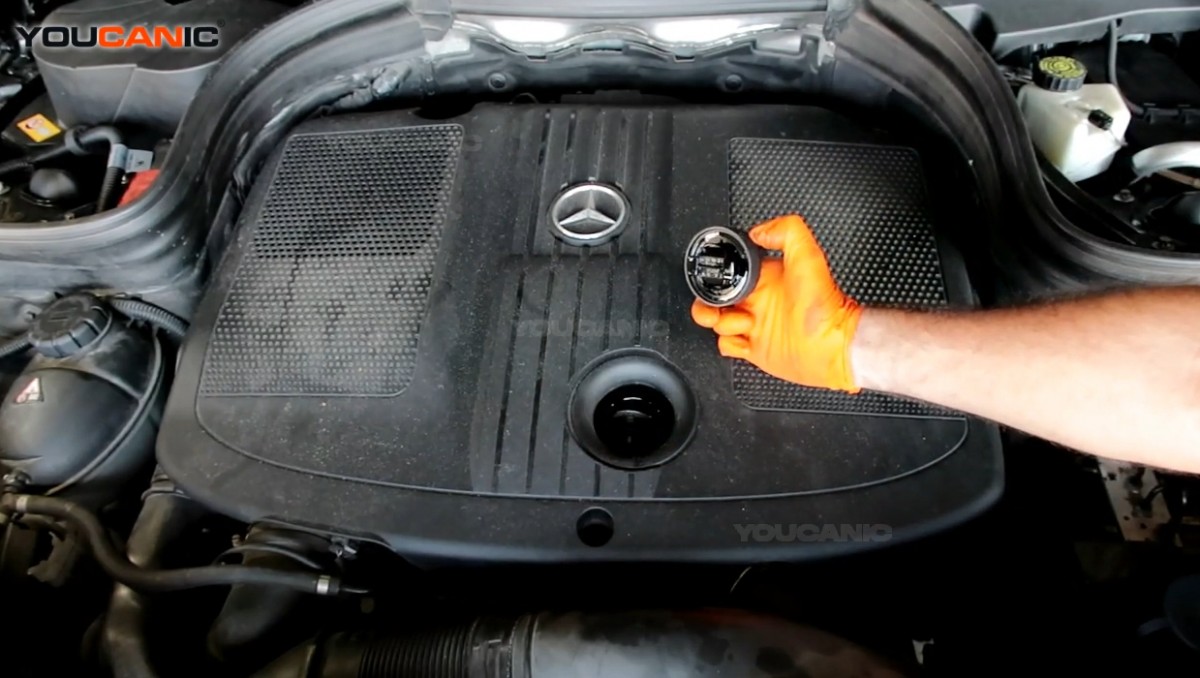 Adding engine oil to the Mercedes Benz SL-Class.