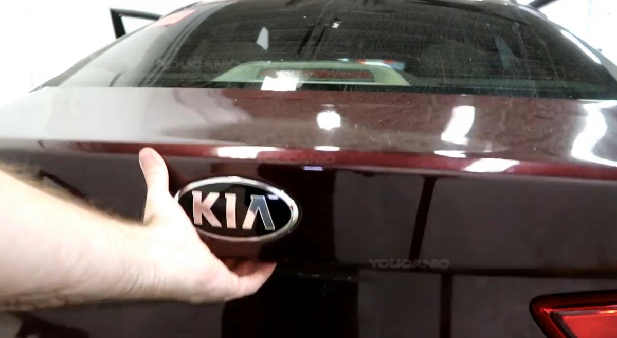 Opening the trunk of the Kia Optima.