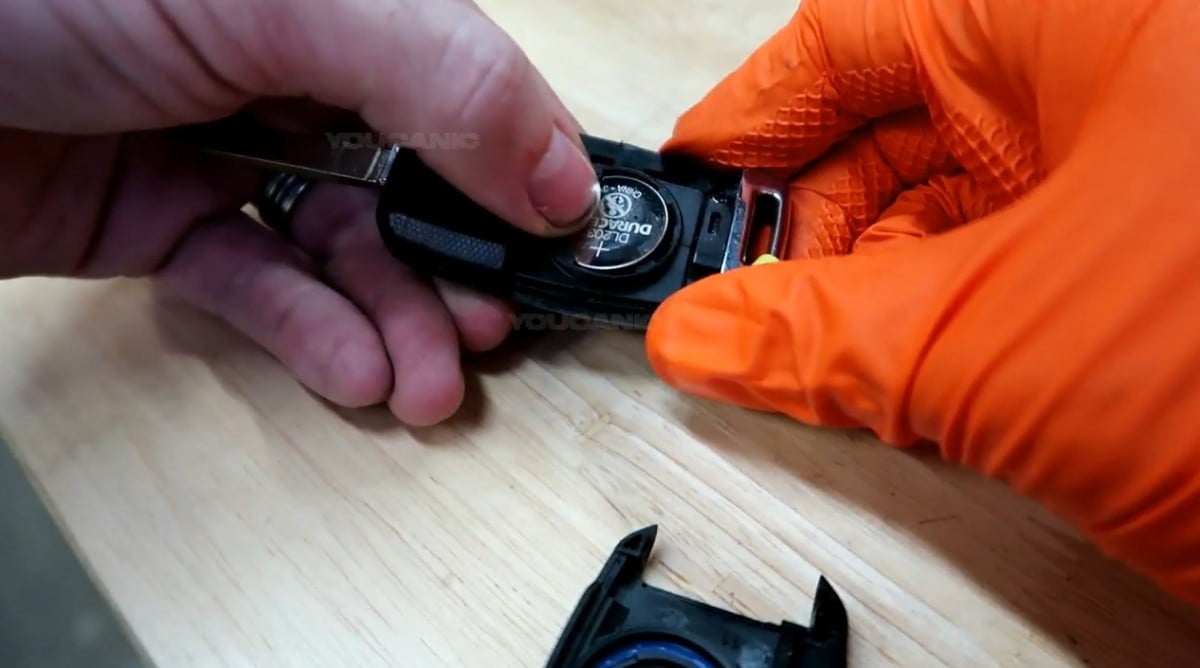 Removing the battery from the key fob.