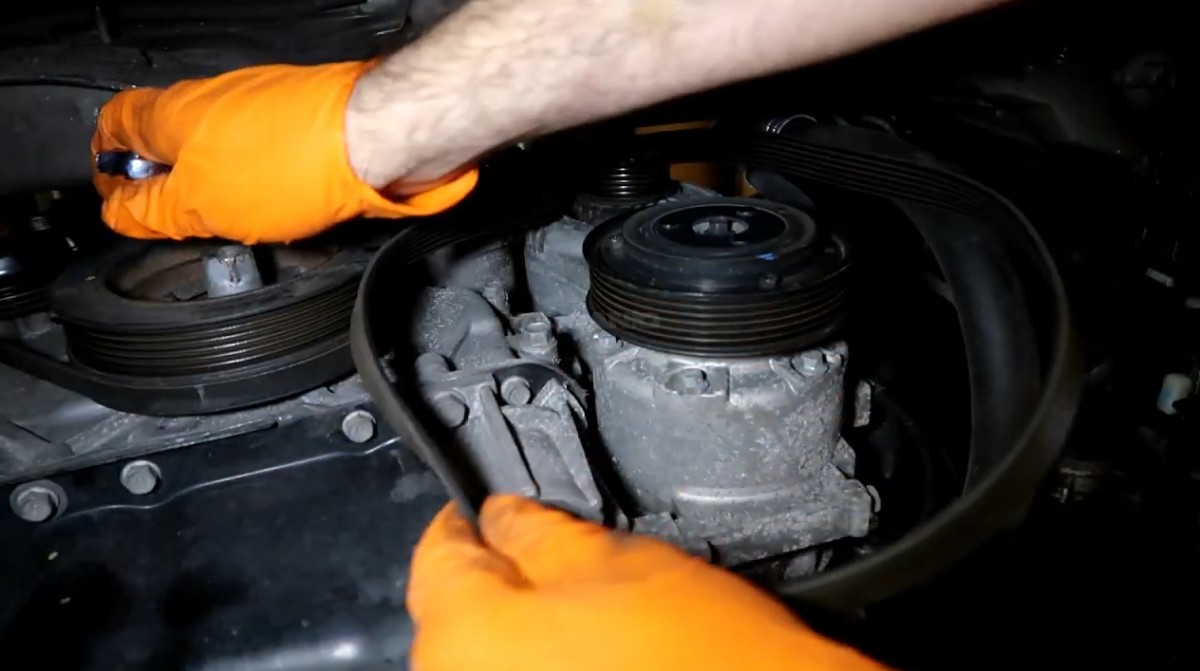Removing the serpentine belt of the vehicle.