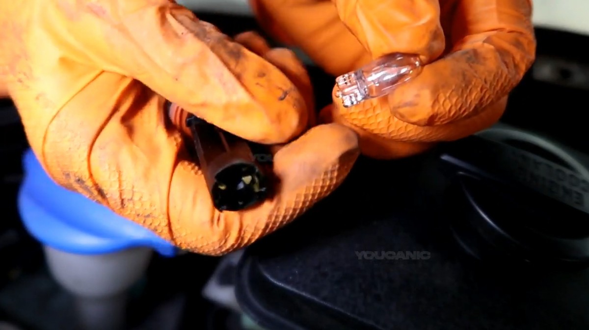 Removing the side marker light bulb from the socket.