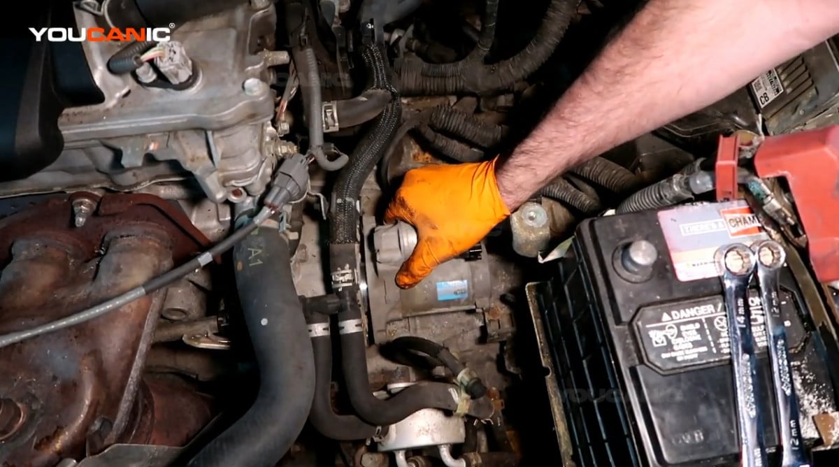 Installing the replacement starter of the Toyota Camry.