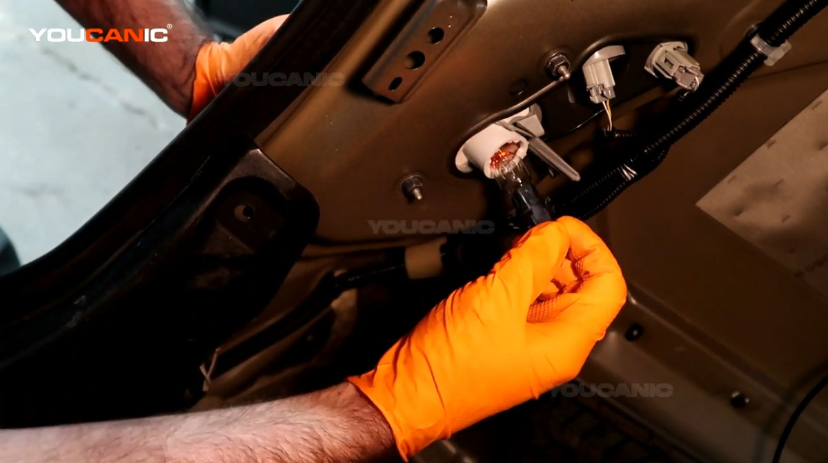 Pulling the brake light connector out.