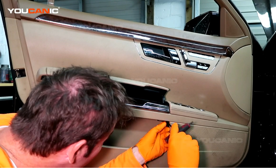 Removing the T30 screws on the door panel.