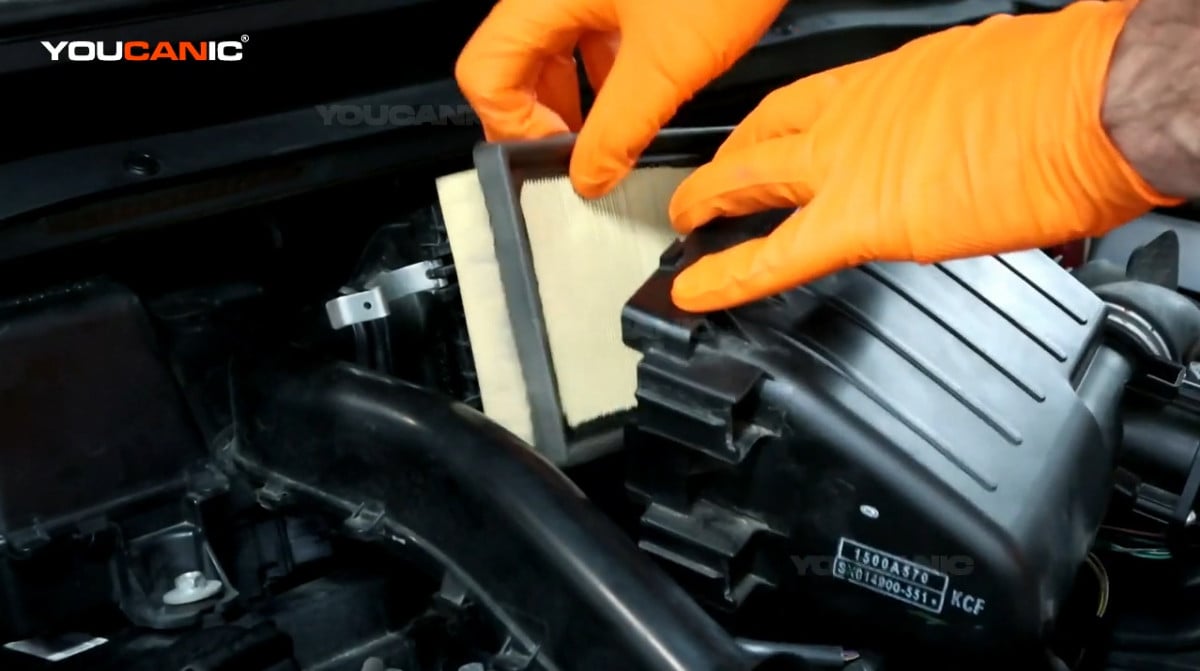 Removing the old air filter of the 2020 Mitsubishi Mirage.