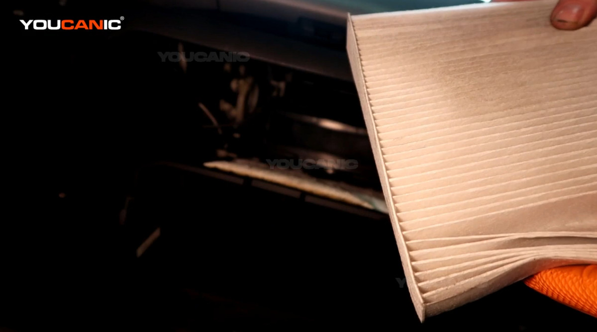 Pulling out the cabin air filter of the 2011 Honda Fit.