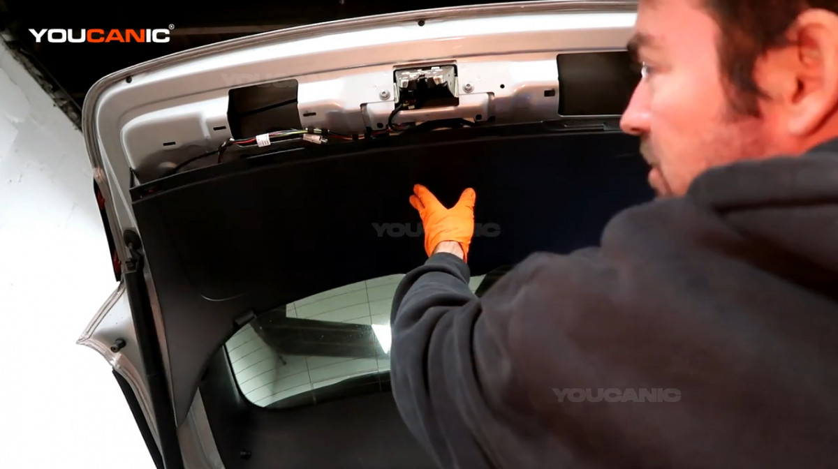 Installing the trunk door panel back to the vehicle.