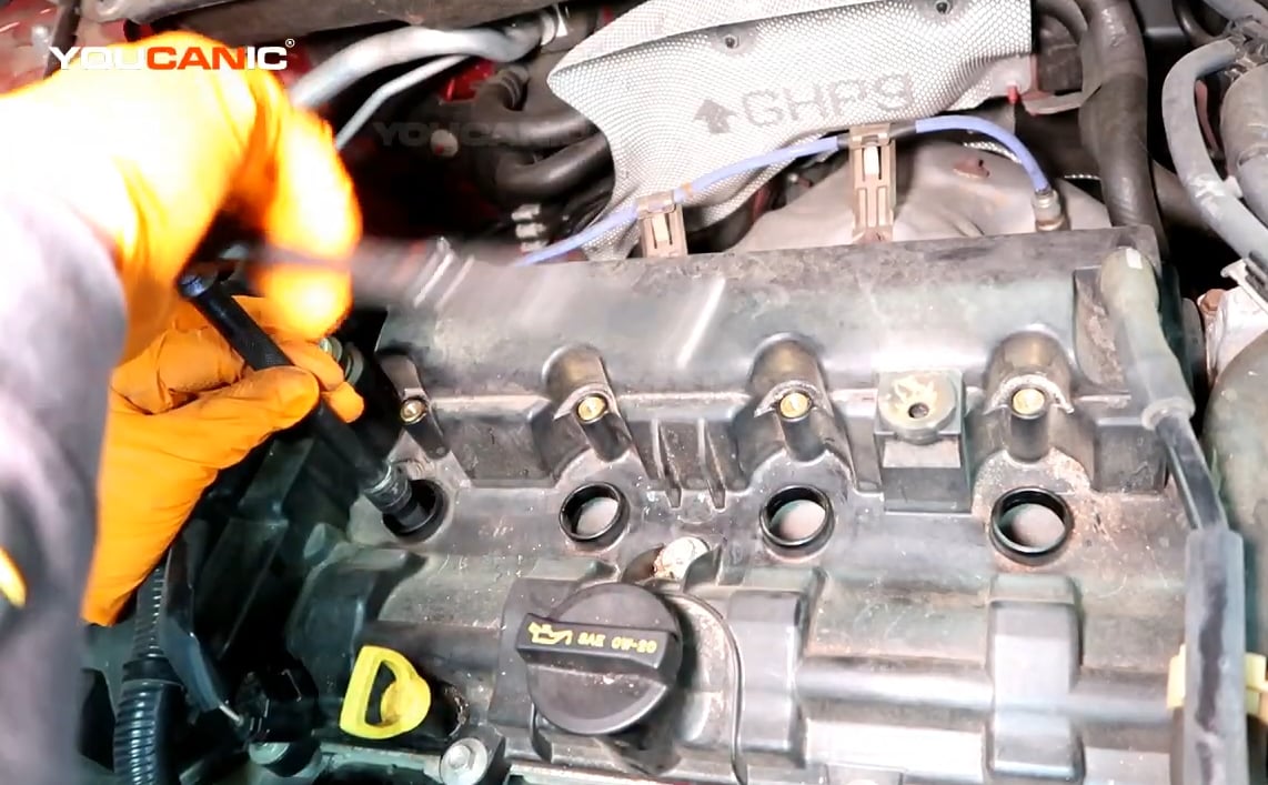 Tightening the spark plugs of the 2016 Mazda 3.