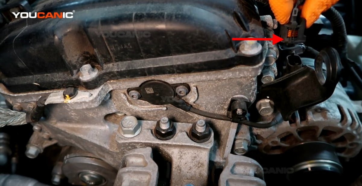 Disconnecting the electrical connector of the camshaft position actuator.