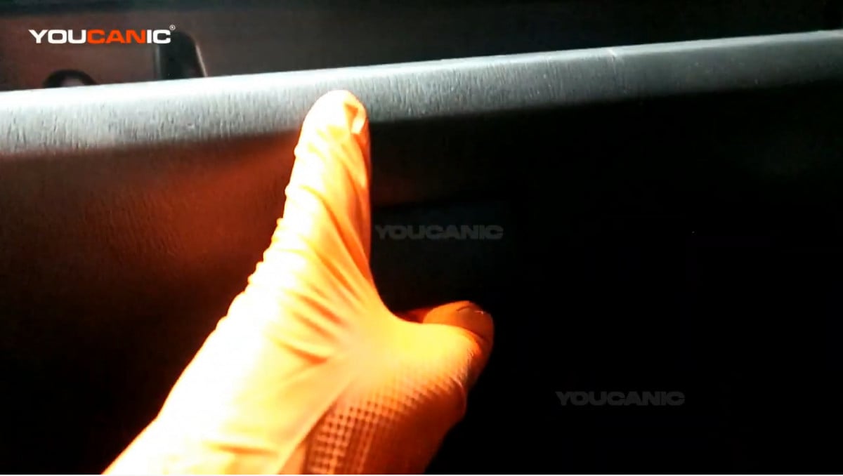 Opening the glove box of the Mazda 3.