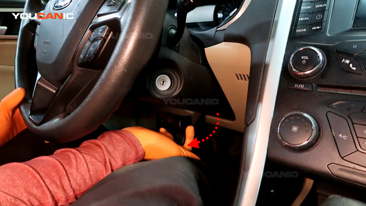 Pulling the steering wheel release lever.
