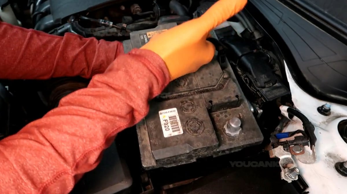 Removing the battery of the Kia Forte.