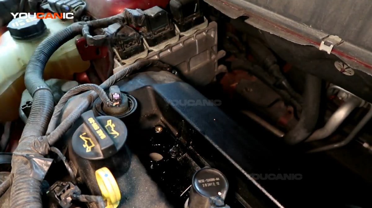 Removing the ignition coil of the Ford Fusion.