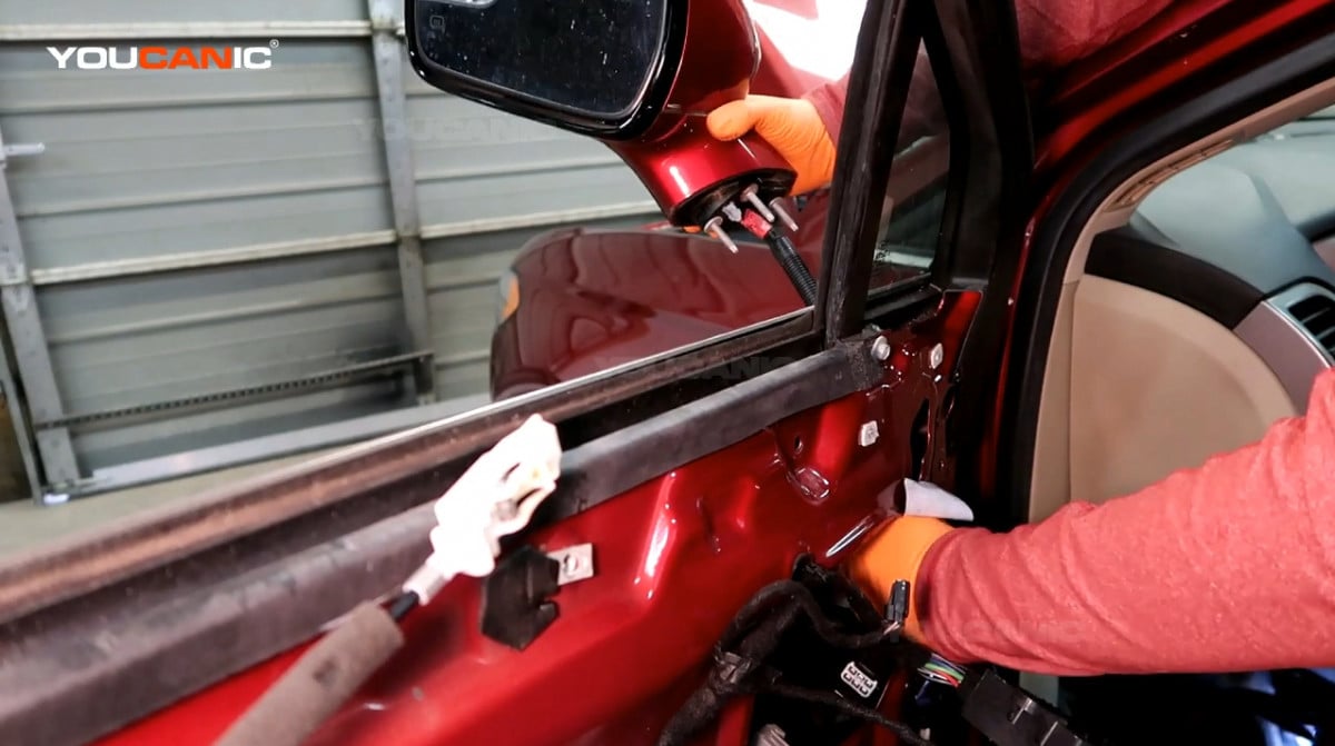 Removing the side mirror of the Ford Fusion.