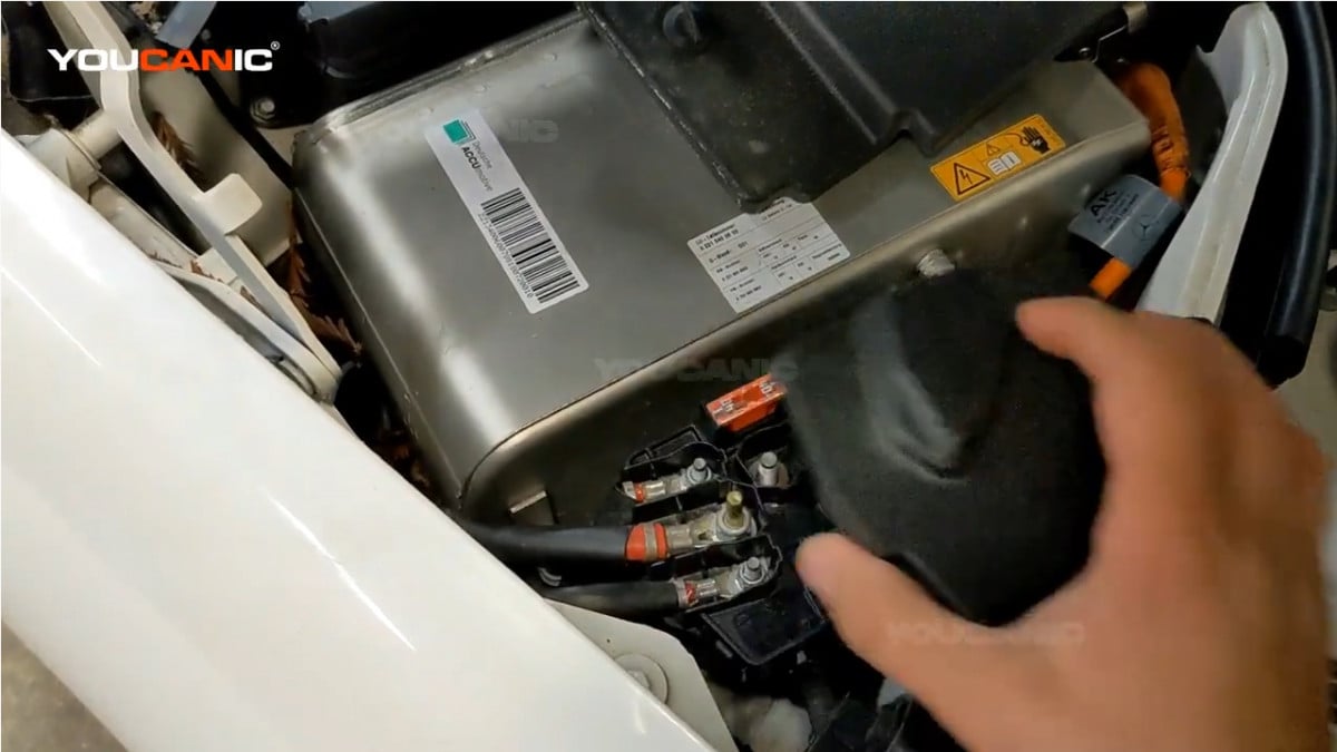 Removing the small cover below the battery.
