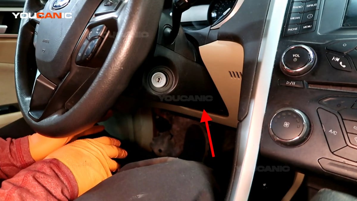 The location of the steering wheel release lever.
