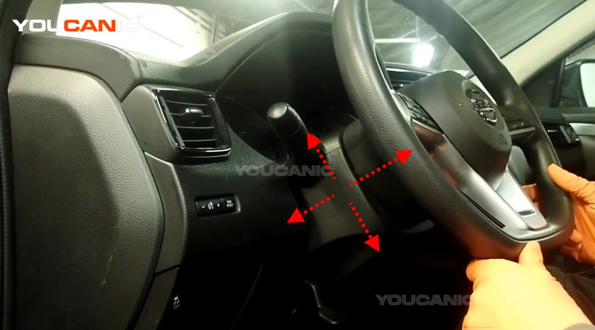 Adjusting the steering wheel of the Nissan Rogue Sport.