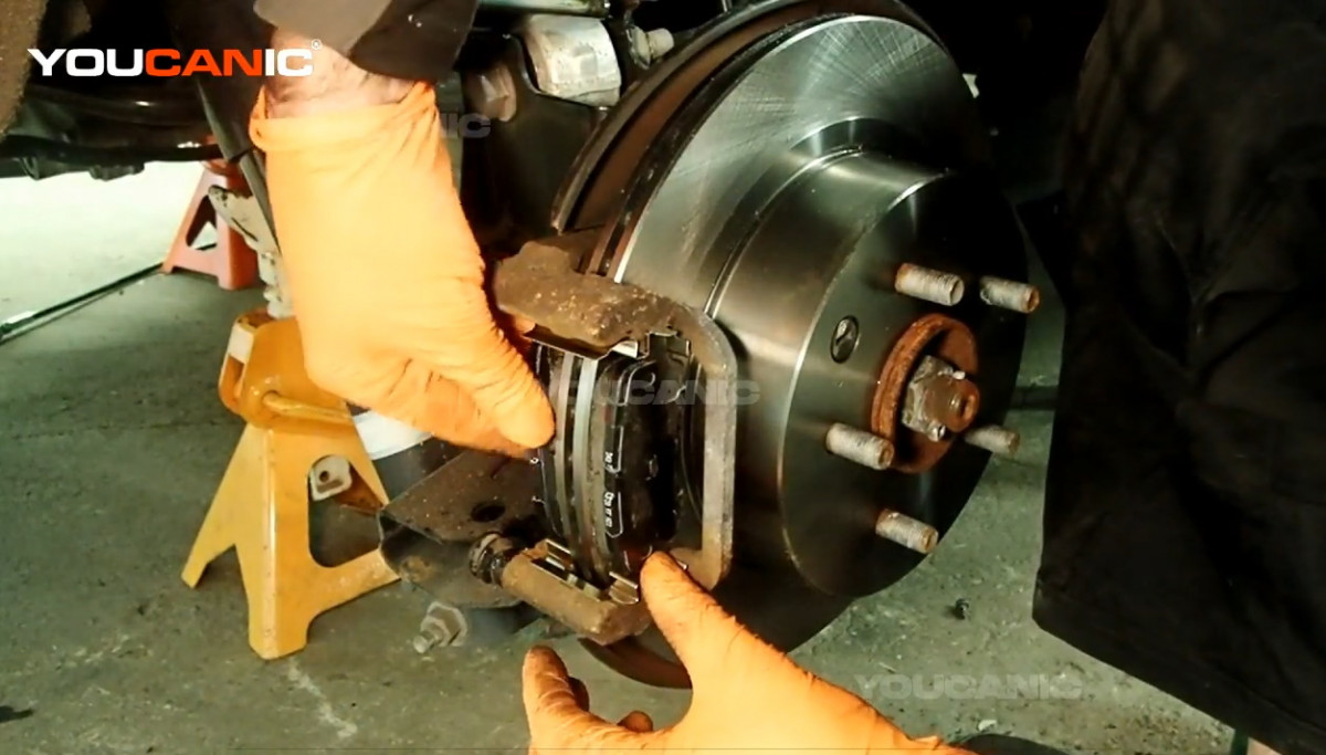 Installing the new brake pads of the Nissan Rogue.