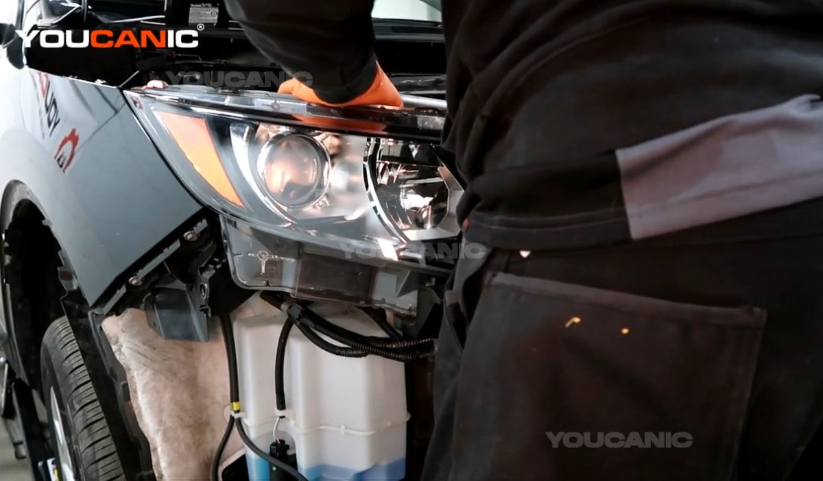 Installing the new headlight assembly of the Nissan Rogue Sport.