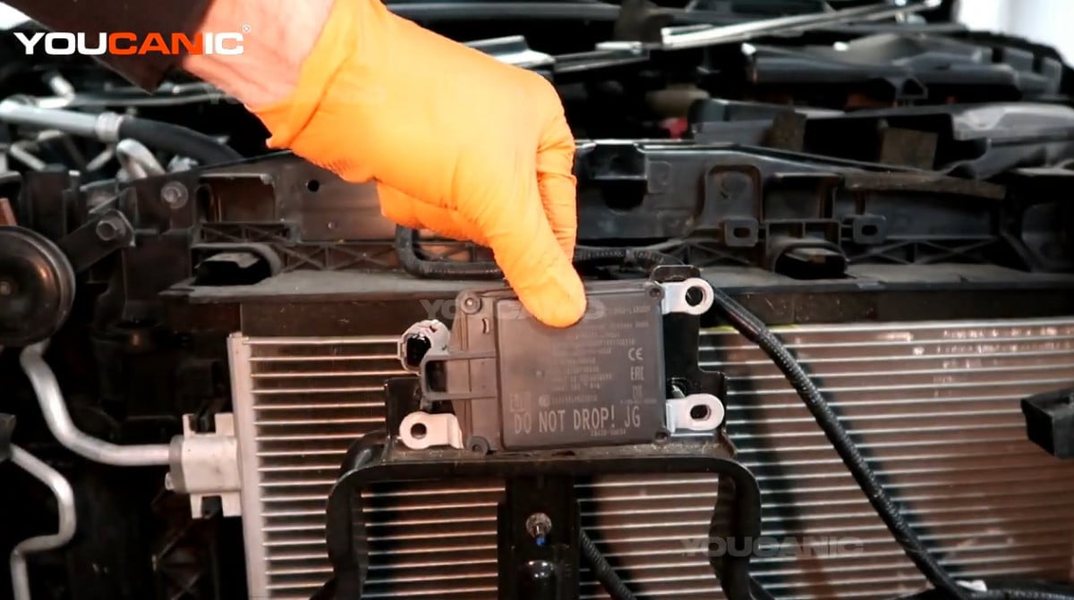 Removing the intelligent forward collision sensor of the Nissan Rogue Sport.