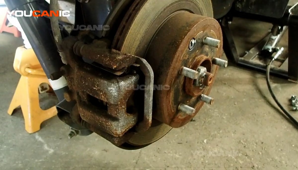 Removing the rear wheel of the Nissan Rogue Sport.