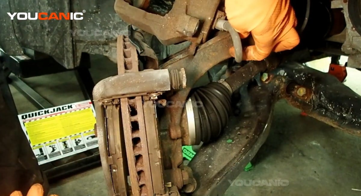 Setting the caliper aside to where the brake cables wont be stretched.