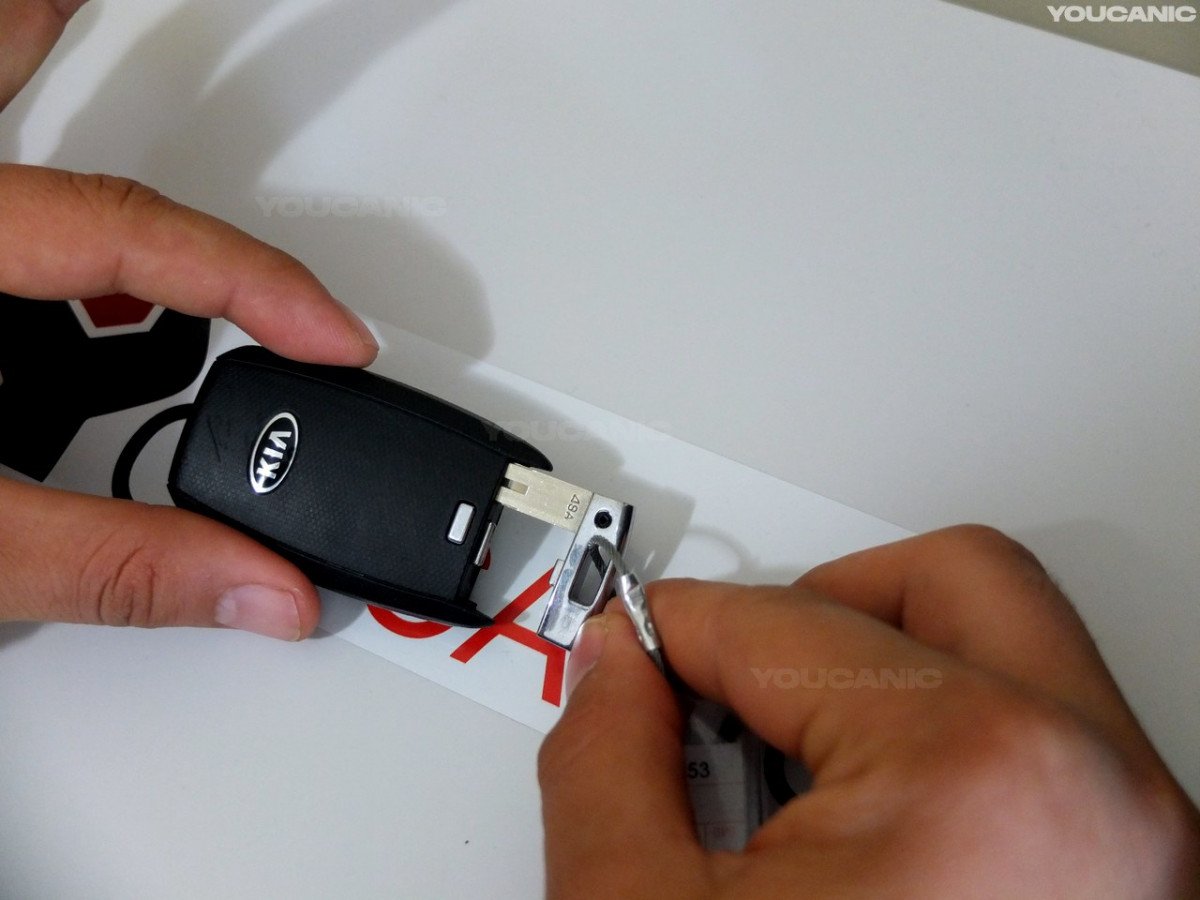Removing the metal key on the key fob.