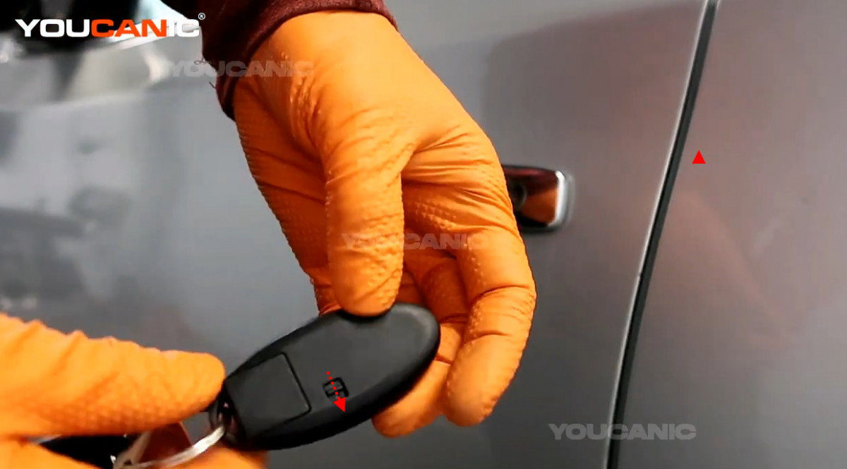 Removing the metal key from the vehicle's key fob.